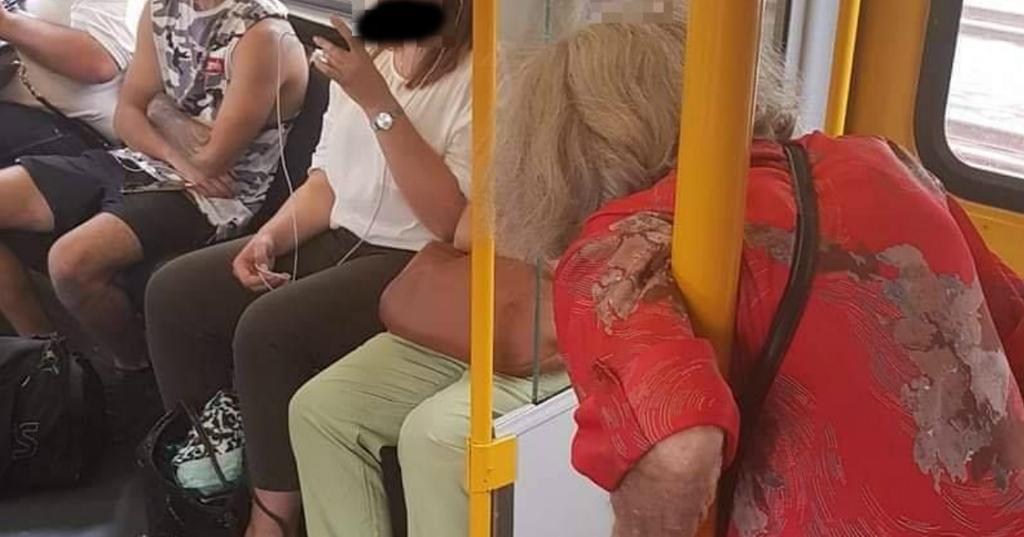 elderly woman standing on train cover