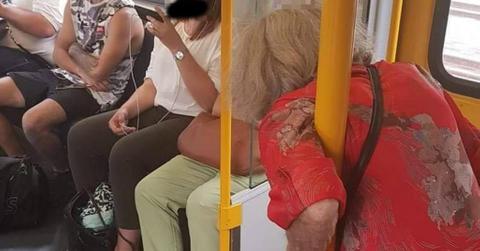 elderly woman standing on train cover